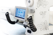 Janome Quilt Maker Pro 20 longarm quilting machine head highlighting the LCD touchscreen and digital tension.
