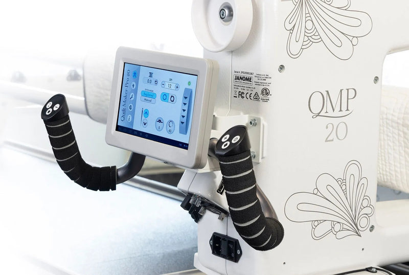 Janome Quilt Maker Pro 20 longarm quilting machine head highlighting the LCD touchscreen and digital tension.