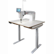 Janome Quilt Maker Pro 20 Versa ST sit-down longarm set into the electronic lift table.