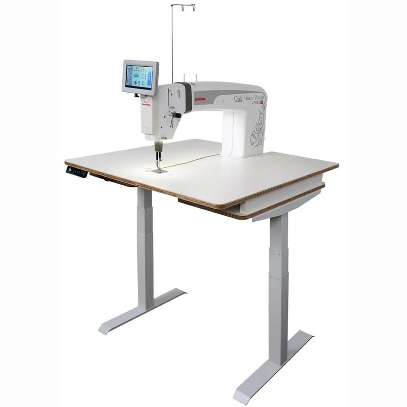 Janome Quilt Maker Pro 20 Versa ST sit-down longarm set into the electronic lift table.