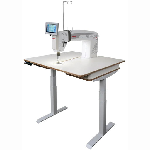Janome Quilt Maker Pro 20 Versa ST sit-down longarm set into the electronic lift table.