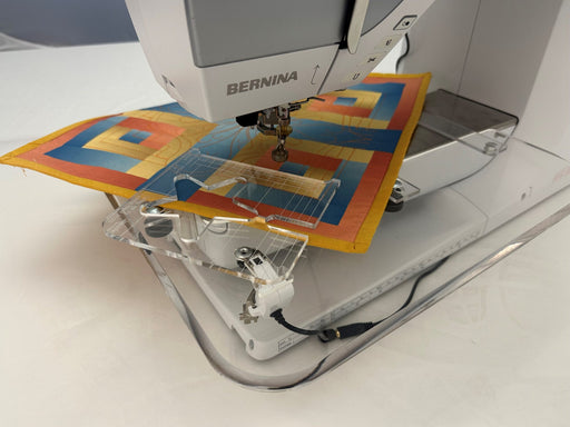 Floating Ruler Base in use with fabric on a quilting frame; machine and frame not included